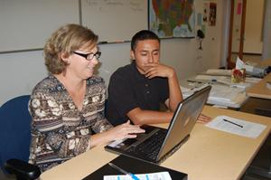 College counselor Regina Risi helps senior Emanuel Ramirez during guidance