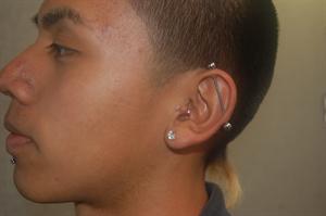 Junior Edward Hinojosa shows off his industrial piercing, one of eight piercings on his body. 