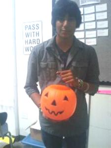 Junior, Cruz Contreras posses with a jack O lanther in honor of the halloween spirit and trick a treating.