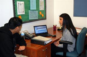 Junior Rolando Granados talks with Leticia Reyes about his grades. He is on the brink of failing several classes and it might affect his GPA, which could eventually affect his eligibility for college.