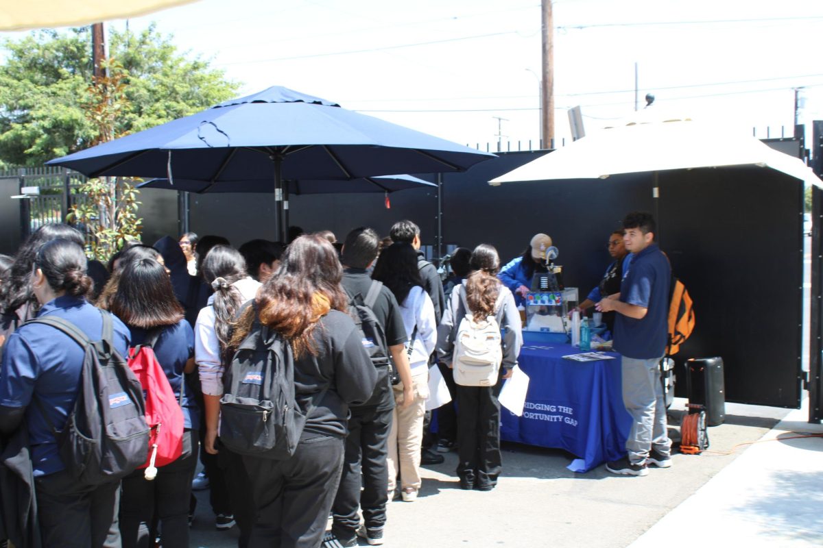 Students are signing up for arc to get snow cones after school on a hot day. 