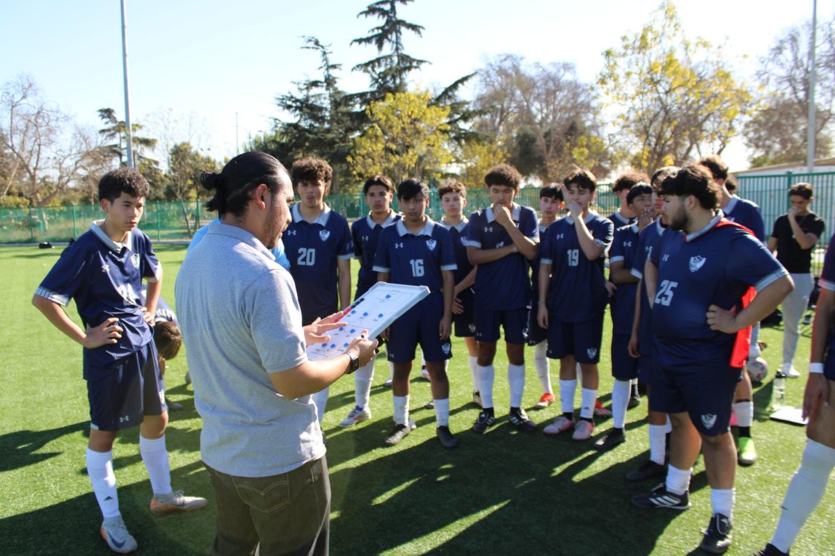 Coach Hinojosa goes over the gameplan with the team.