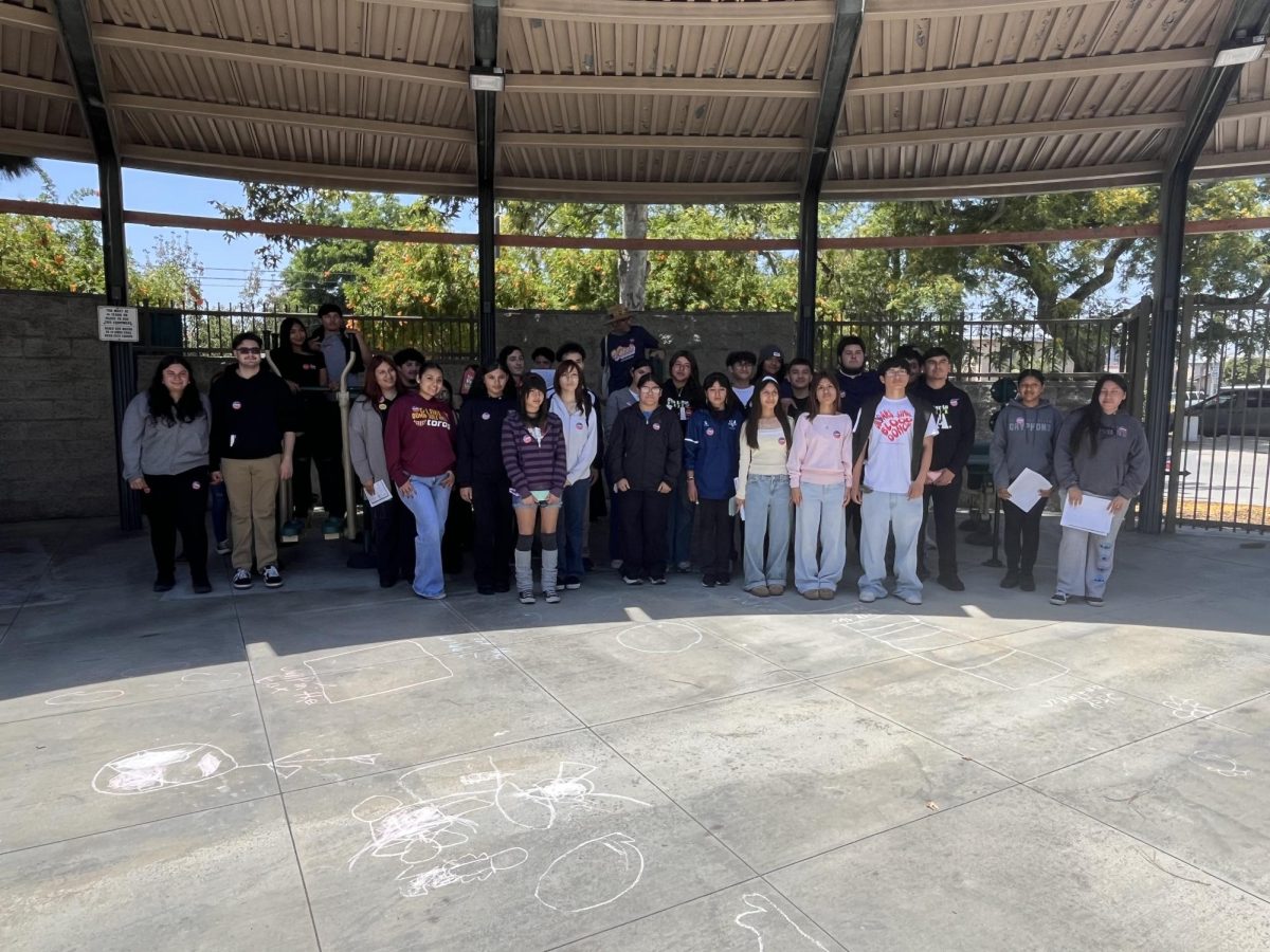 Student voters stop by for a group photo outside the polling place at Washington Park